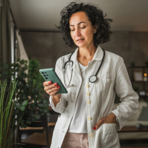 Doctor (woman) checking her website on cell phone